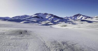 CGI Snow covered mountains under a clear sky at sunrise in a remote location video