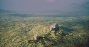 CGI Vast landscape with large rocks and hazy mountains under soft sunlight video