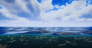 CGI Calm ocean surface under a blue sky with fluffy clouds and gentle waves video