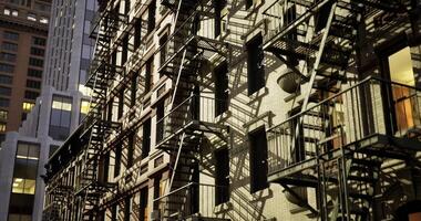 CGI Urban architecture showcases fire escapes and shadows at twilight hour video