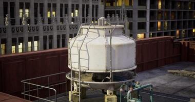 CGI Water tower on urban rooftop at dusk surrounded by skyscrapers video
