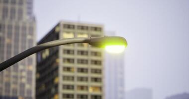 CGI Bright streetlight illuminating urban buildings during twilight hours video