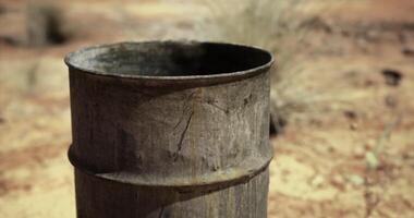 CGI Rusty barrel in a desert landscape surrounded by dry grass and soil video