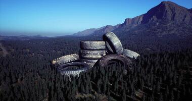 CGI Mountains surrounded by abandoned tires in a forested area video