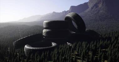 CGI Used tires stacked in a forest setting during late afternoon light video