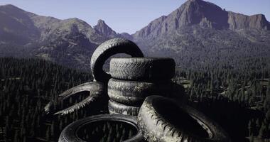 CGI Piles of discarded tires in a mountainous landscape with dense forest video
