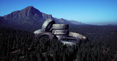 CGI Abandoned tires on a mountain landscape surrounded by dense forest video