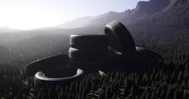 CGI Large pile of discarded tires in a green forested mountain area video