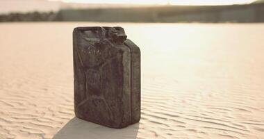 CGI Rusty canister rests on sandy ground under bright sunlight in open area video