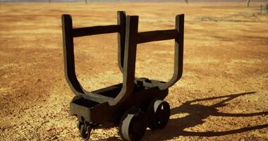 CGI Old mining cart resting on dusty ground in arid landscape near a desert video