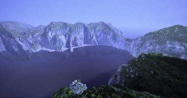 CGI Majestic mountain landscape overlooking a tranquil lake in serene light video