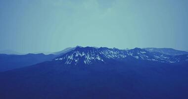 CGI Snowy mountain landscape at dusk with a blue sky above video