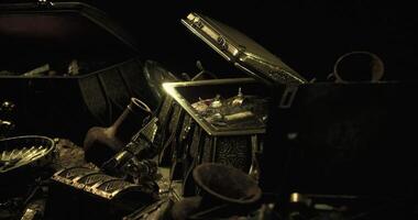 CGI Curious treasures scattered across a dark surface in a mysterious setting video