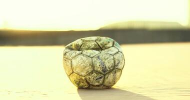 CGI Unique soccer ball converted into a decorative item on sandy beach at sunset video