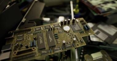 CGI Motherboard on workbench surrounded by other electronic components in workshop video