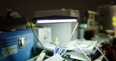 CGI Dimly lit workspace filled with tools and materials at night video