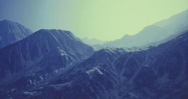 CGI Mountains bathed in soft light revealing textured peaks and valleys video