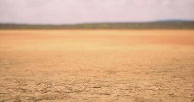 CGI Dry cracked earth under a cloudy sky in a remote landscape during daytime video