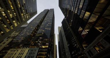 CGI Modern skyscrapers reaching towards the sky in an urban landscape at dusk video