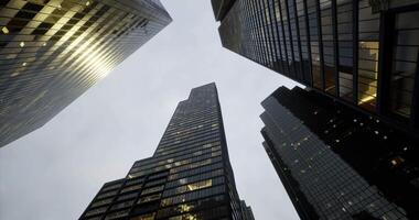 CGI Tall skyscrapers rising towards the cloudy sky in an urban setting video
