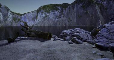CGI Serene lakeside view with rocky cliffs and natural landscape during twilight video