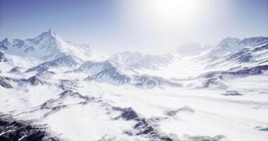 CGI Snow covered mountain landscape bathed in bright sunlight on a clear day video