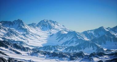 CGI Majestic snow capped mountains under clear blue sky during daytime video