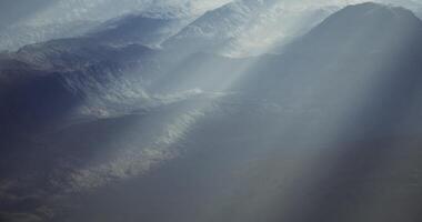 CGI Dramatic mountain landscape with sunlight streaming through clouds video