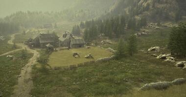 CGI Rustic farmstead surrounded by mountains in early morning fog video