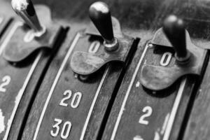 Vintage cash register buttons showcase intricate design and history in a warm-toned shop during the afternoon hours photo