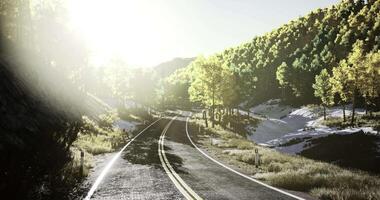 CGI Scenic winding road through green hills with sunlight shining in background video
