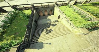 CGI Steps leading to a park entrance in a city during daylight with greenery video
