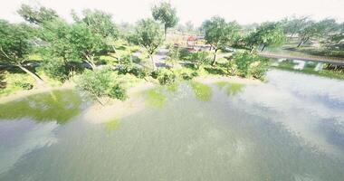 CGI Lush riverside park with greenery and calm water under bright sunlight video