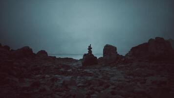 CGI Rock formations stand against a gloomy ocean backdrop at twilight video