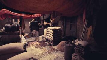 CGI Sacks of various grains and goods are stacked in a dimly lit old bazaar video