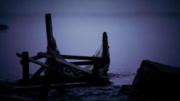 CGI Ruined wooden dock at dusk near calm water with fog on the horizon video