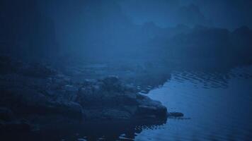 CGI Misty water landscape with rocks reflecting in the twilight glow video