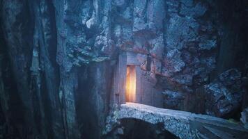 CGI Mysterious glowing doorway in a rocky cavern with a wooden bridge video