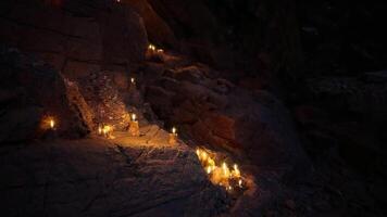 CGI Candles illuminating a rocky path in a dark cave at night video