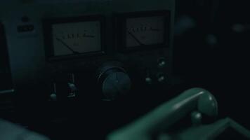 CGI Close up view of vintage audio equipment with dials and meters in low light video