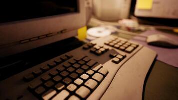 CGI Old computer keyboard and monitor setup in an office environment at dusk video