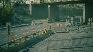 CGI Road construction with barriers and signage under a bridge in autumn video