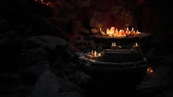 CGI Candles illuminate a mystical cave altar during an evening ceremony video