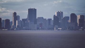 CGI View of a modern skyline with skyscrapers along the waterfront under cloudy sky video