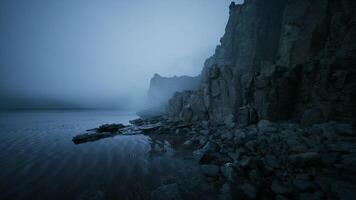 CGI Misty cliffs line the tranquil waters edge during early morning hours video