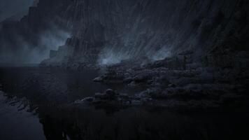 CGI Mysterious shoreline at dusk with fog and rocky cliffs in the background video