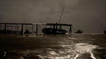 CGI Dark waters surround fishing boats at dusk with cloudy skies video