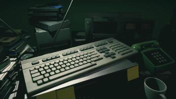 CGI Old keyboard and retro technology cluttered on a desk in a dimly lit room video