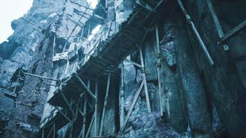 CGI Ancient ruins with scaffolding under gray cloudy sky in mountainous region video