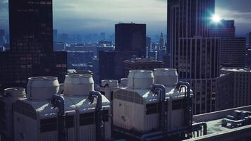CGI Overview of city rooftops with industrial cooling towers in urban skyline video